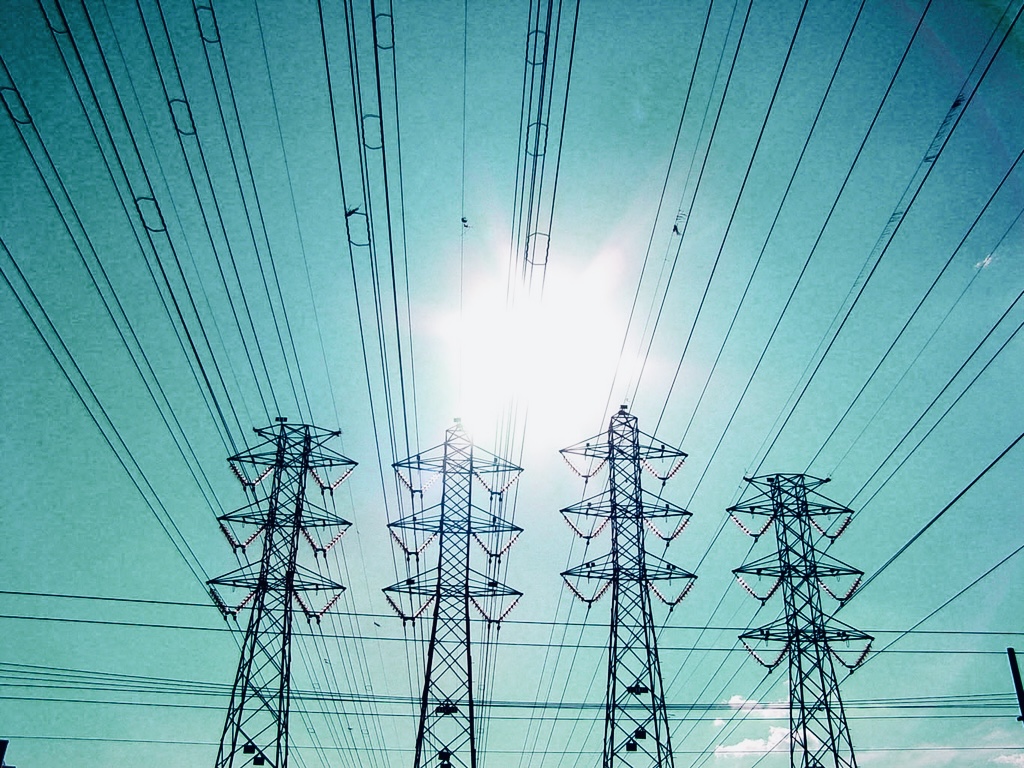 image of pylons with blue background and sun